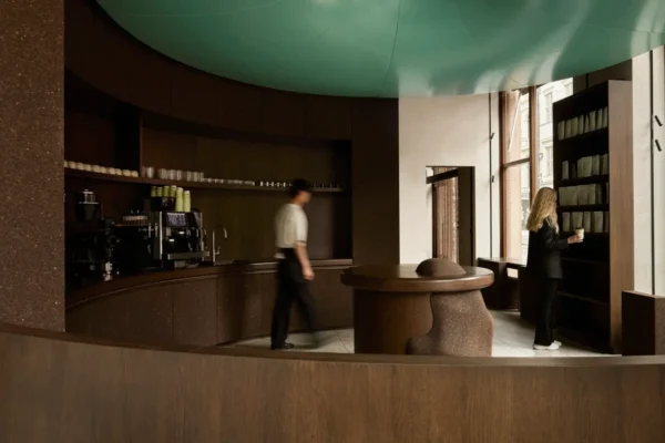 Circular coffee counter beneath a turquoise ceiling installation at Elan