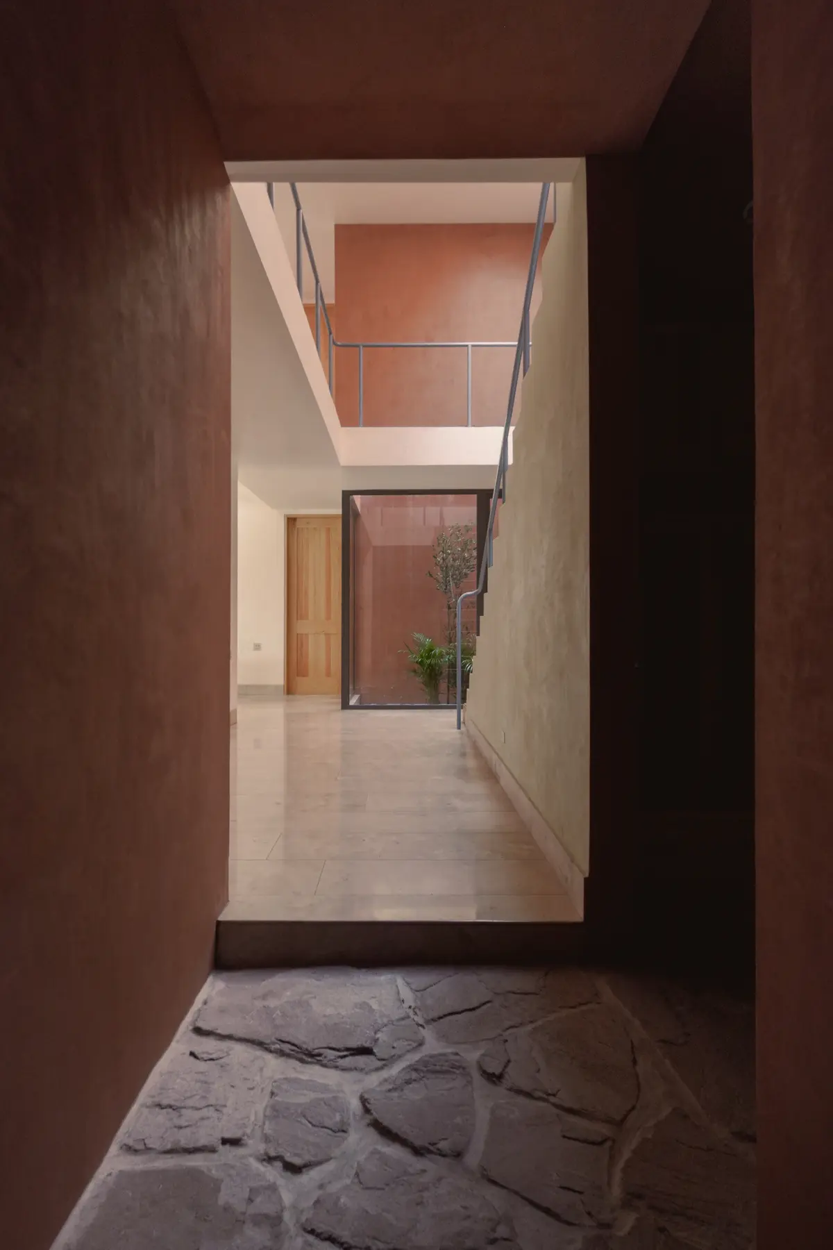 Narrow entrance passage opening towards a courtyard at Hosho House