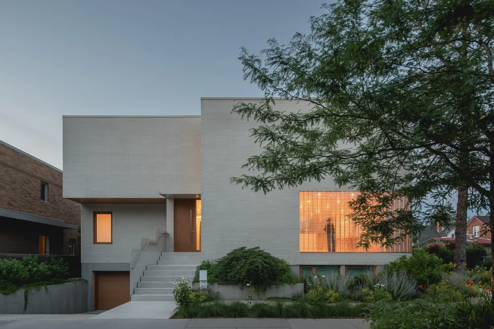 The Lens House lit from within at dusk, photograph by Raphaël Thibodeau