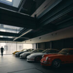 Private Porsche collection in a dark gallery with glazed openings