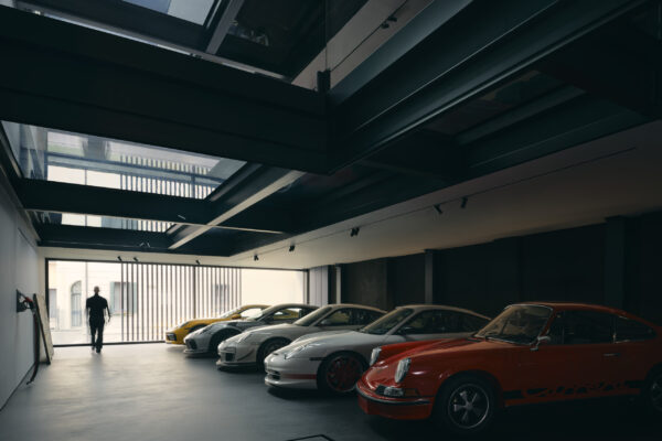 Private Porsche collection in a dark gallery with glazed openings