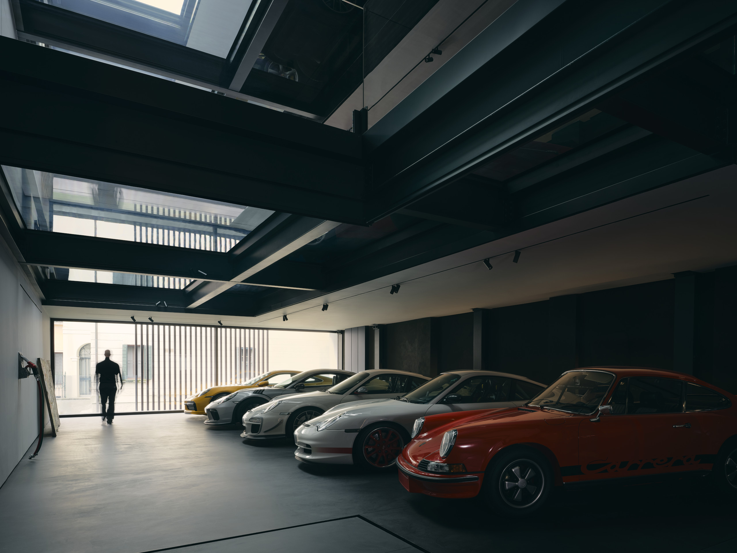 Private Porsche collection in a dark gallery with glazed openings